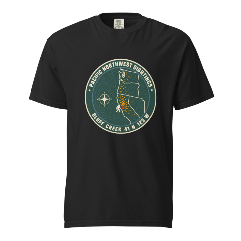 Round Bigfoot sightings badge reading Pacific Northwest Sightings and Bluff Creek 41 N 123 W, with a map of the coast and a red X, on a black heavyweight tee.