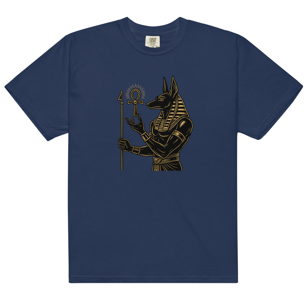 Anubis, Egyptian god of the afterlife, in black and gold holding an ankh, on a true navy heavyweight tee, front view.