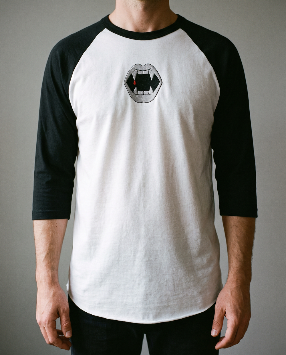 Fangs Raglan, White/Black, worn, chest detail, embroidered fangs on Tultex 245 raglan