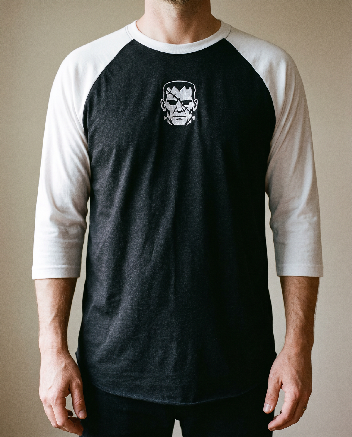 Frankenstein's Creature Raglan, Black/White, worn, chest detail, embroidered creature on Tultex 245 raglan