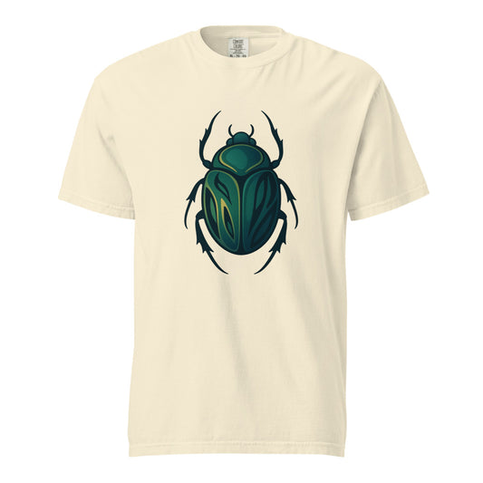 An emerald and gold Egyptian scarab beetle with a dark outline, the symbol of Khepri and rebirth, on an ivory heavyweight Comfort Colors tee.