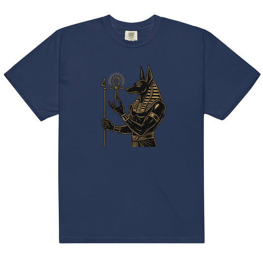 Anubis, Egyptian god of the afterlife, in black and gold holding an ankh, on a true navy heavyweight tee, front view.