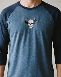 Winged Skull Raglan, Heather Denim/Navy, worn, torso view, embroidered winged skull
